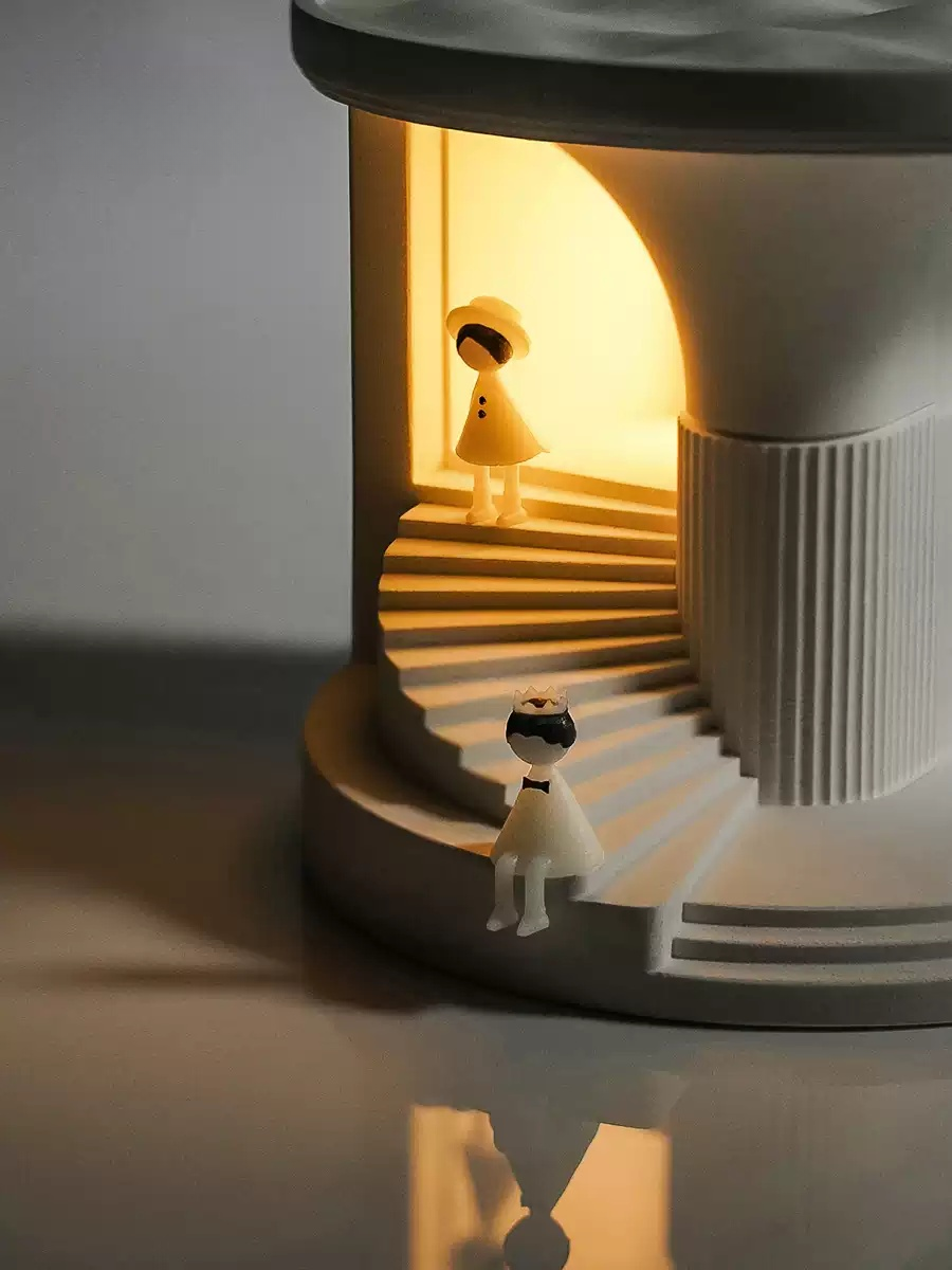 Close view of cement night light with tiny figures and warm ambient light