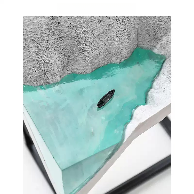 Close-up of glacier stone decor with tiny boat detail