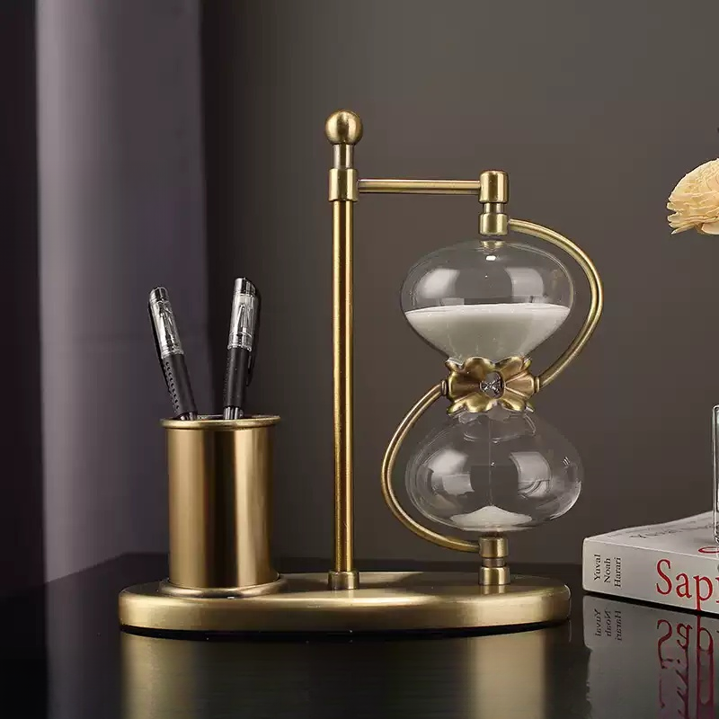 Gold hourglass pen holder on desk for premium room decoration