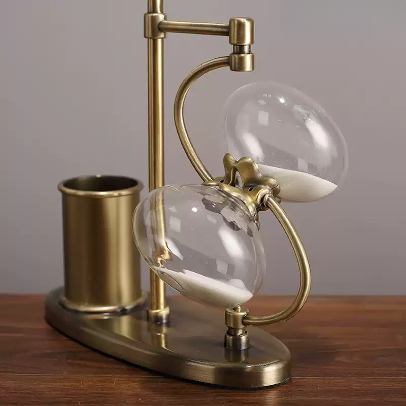 Close view of rotating hourglass decor attached to pen holder base