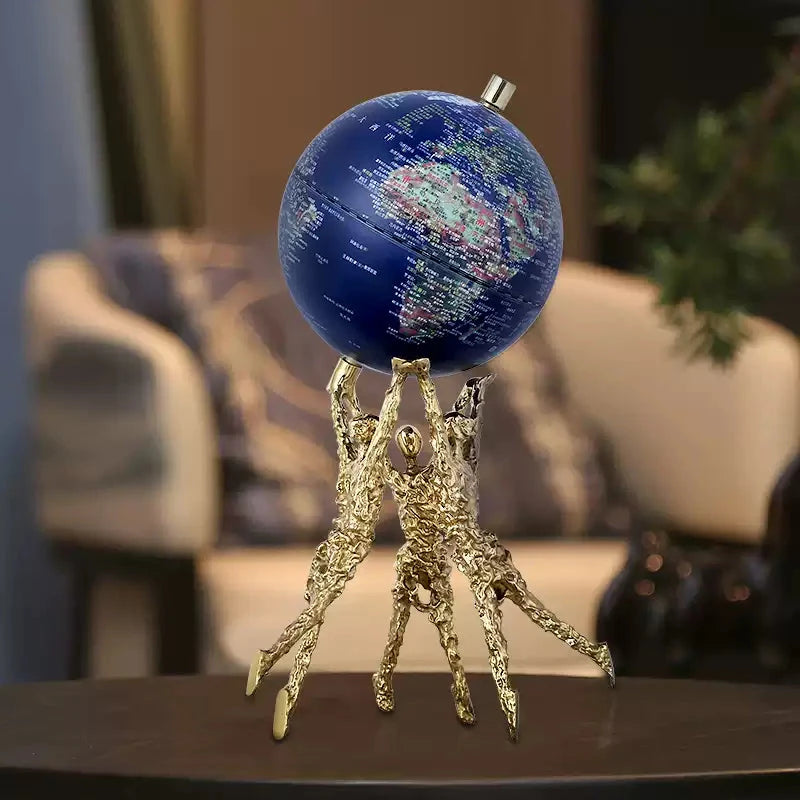 Blue globe decoration lifted by abstract brass figures for modern room decoration and birthday gift