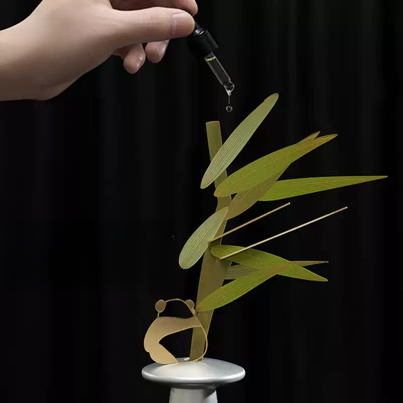 Drop essential oil onto bamboo leaves aroma diffuser for home fragrance